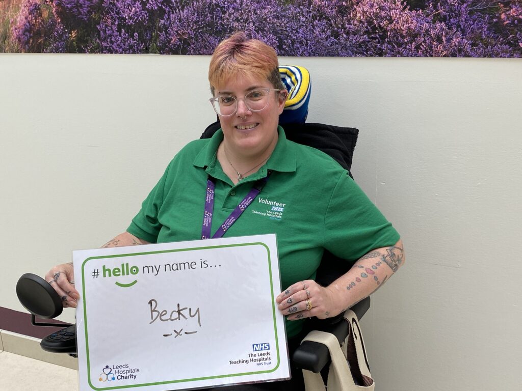 Becky one of our Hospitals volunteers introducing herself to us by holding a Hello My Name is badge