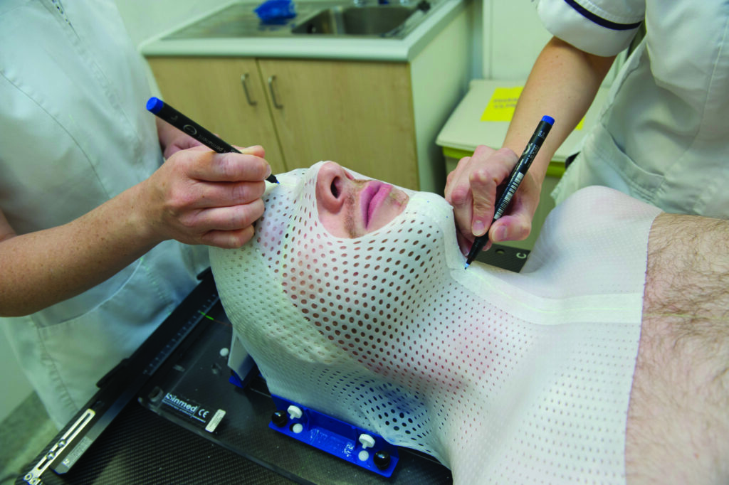 A photograph of a patient having a plastic mask made.