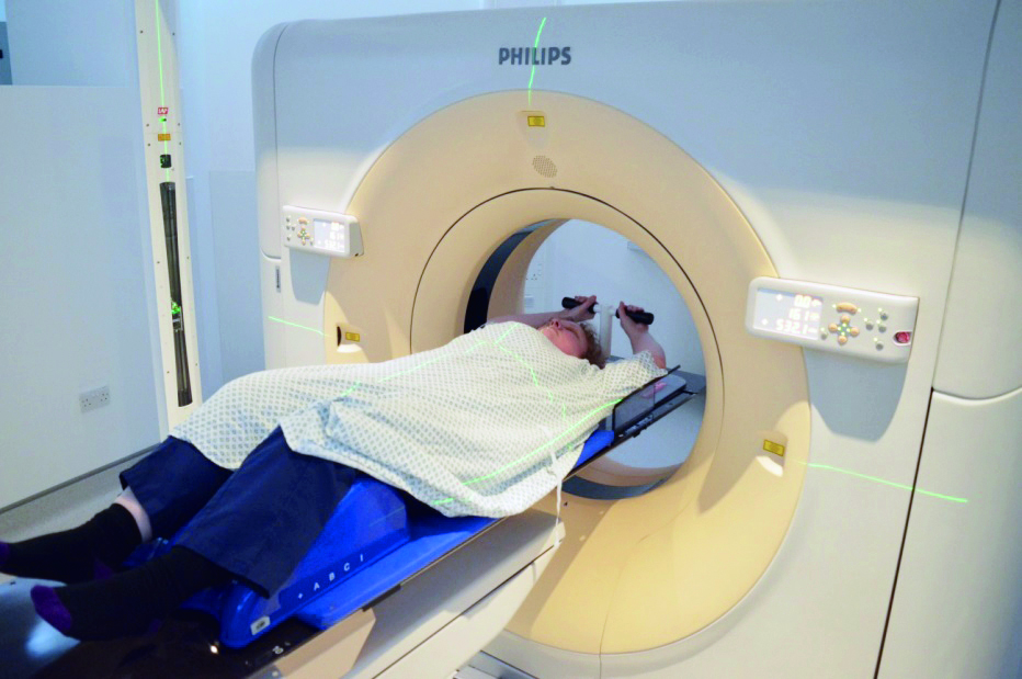 Photograph of a patient having a planning CT scan on a CT scanner.