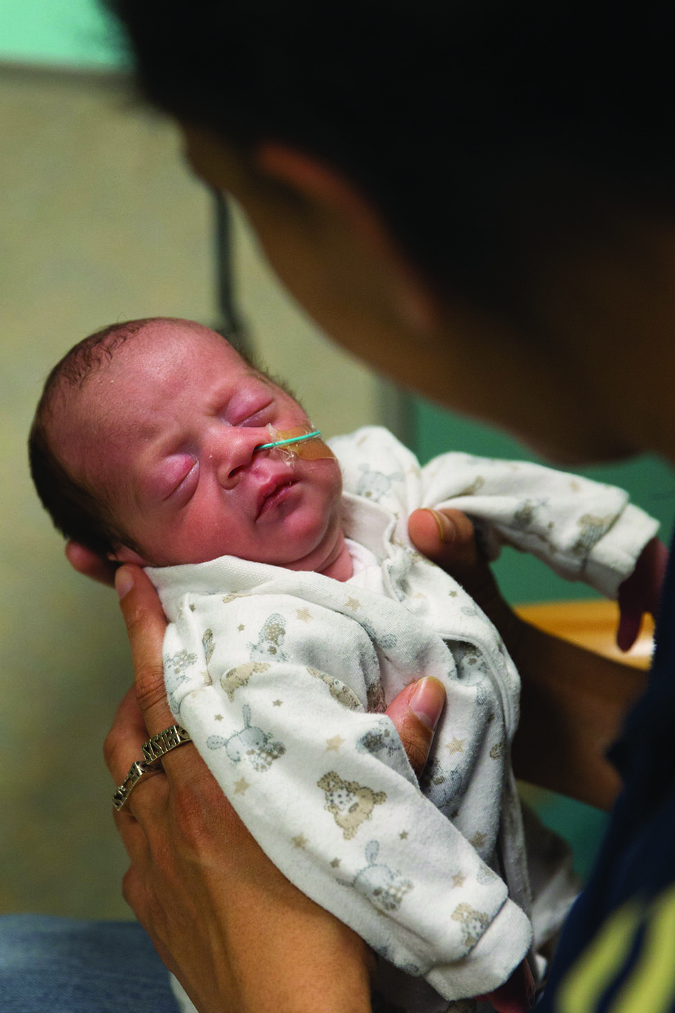 Photograph of a parent holding a new born baby