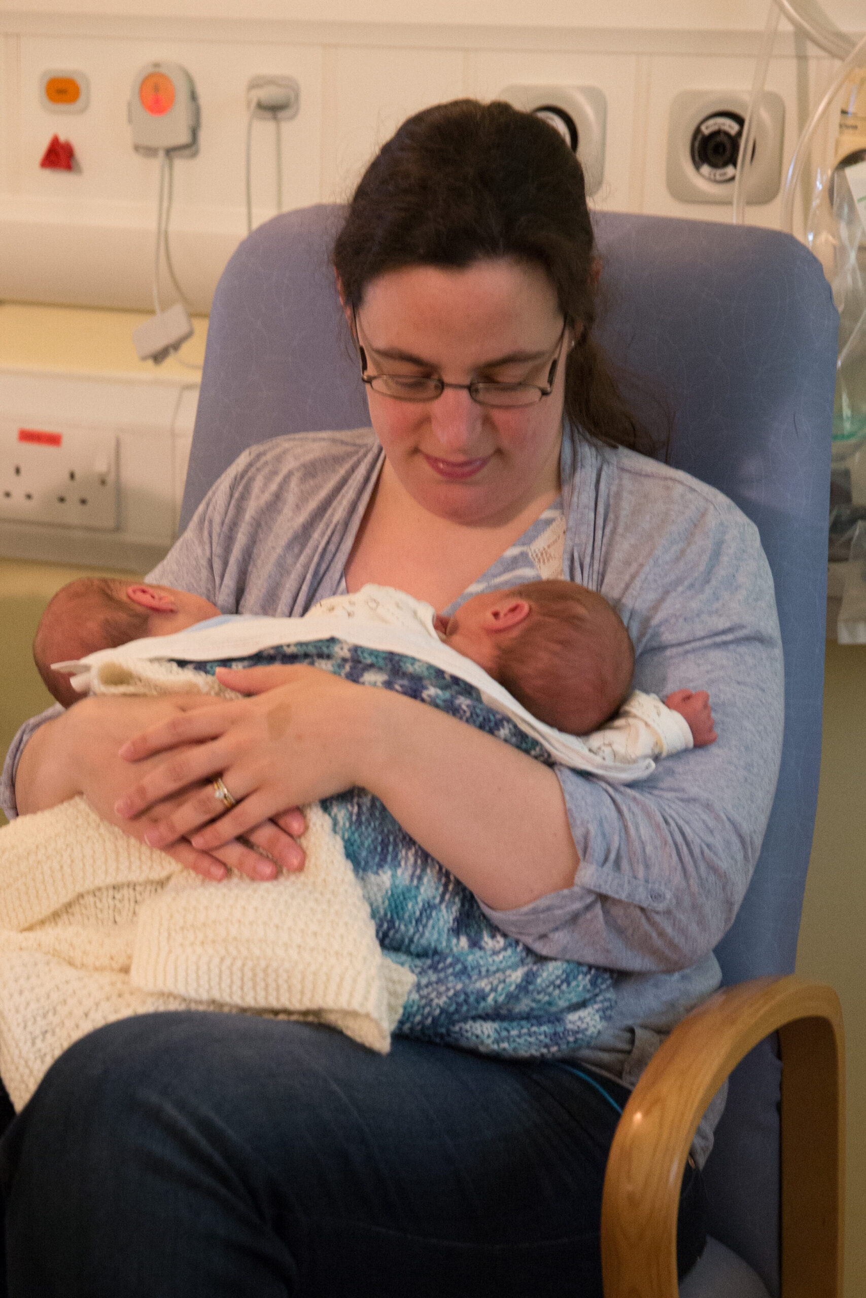 Photograph of parent holding new born twins