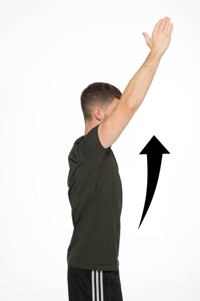 Photograph of a person raising their arms straight up above their head.