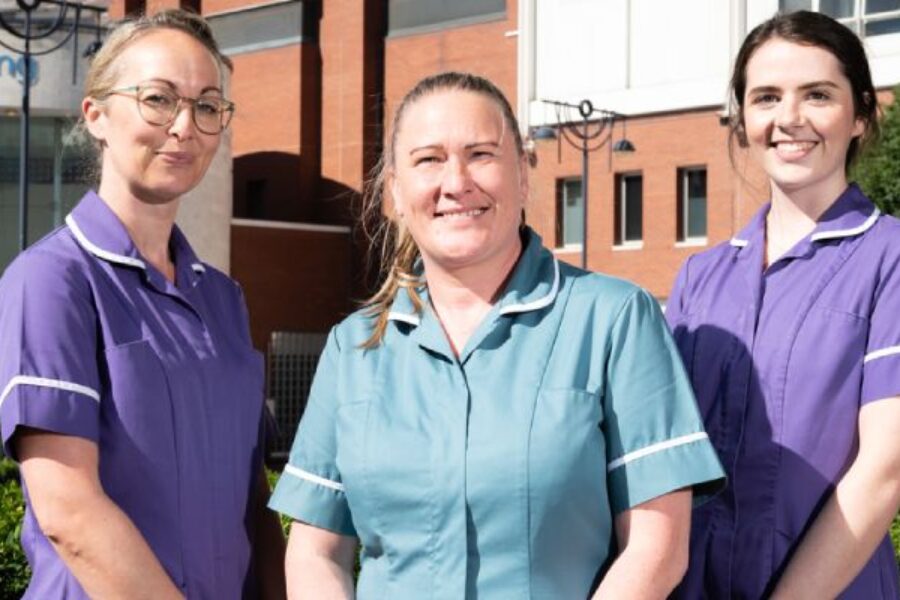Three of the midwives team smiling at the camera