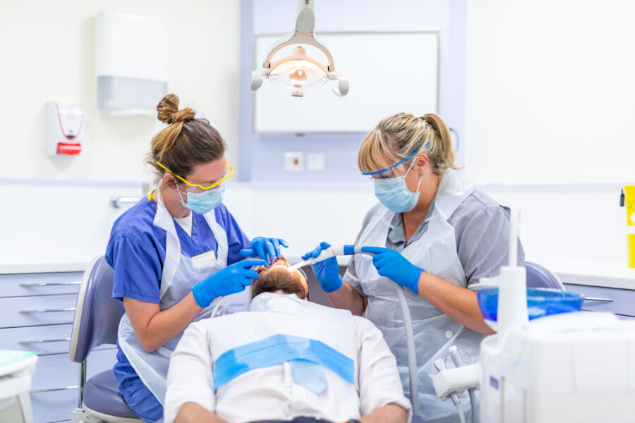 Dentist and nurse treating a patient