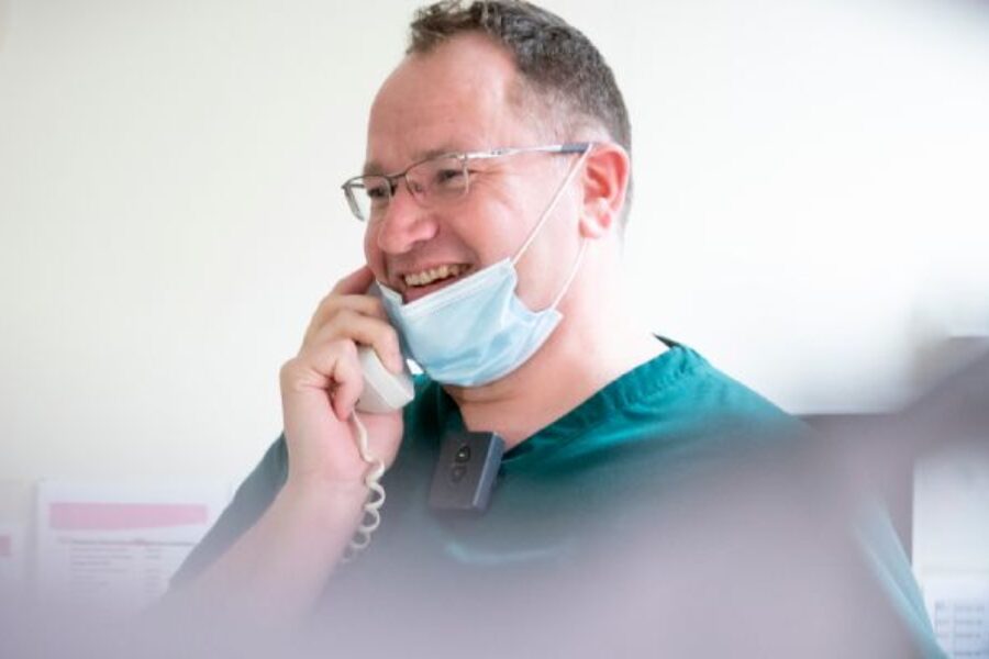 Smiling clinical staff on phone
