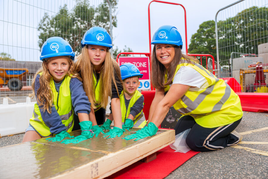 Lindsey Burrow and her children lay their hands in concrete to leave their mark on the new Rob Burrow Centre for Motor Neurone Disease.